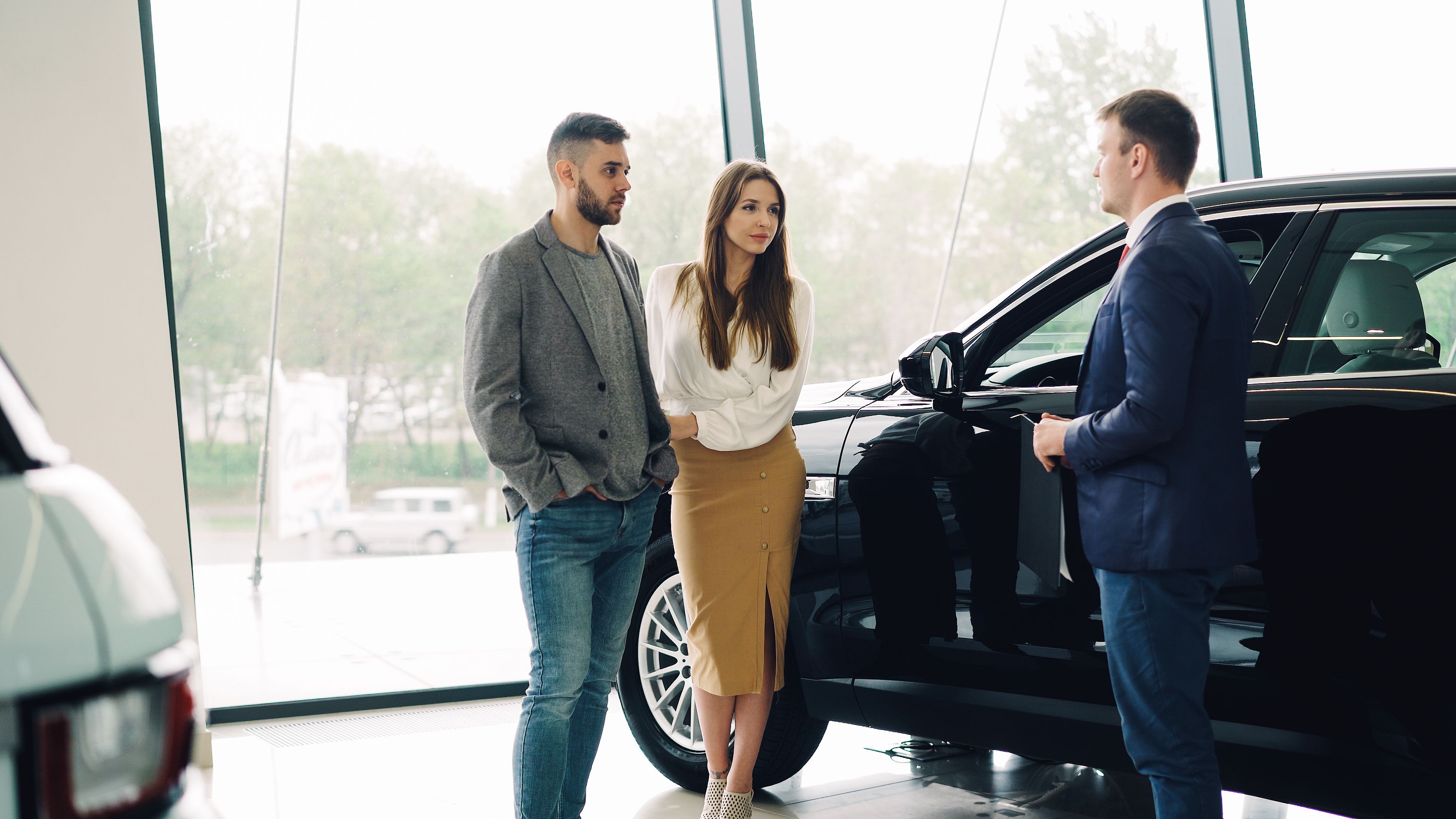 Car finance customer with a broker at a dealership